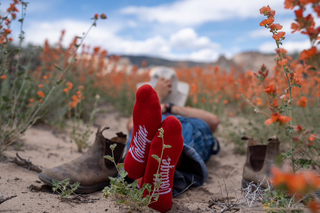 Man standing on soapy ground wearing red lucky socks
