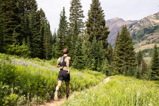 motion shot of Johnny Collinson trail running in mountains wearing Sweat KOM Socks