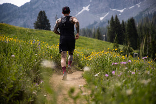 Johnny Collinson trail running in the mountains wearing voltage gear