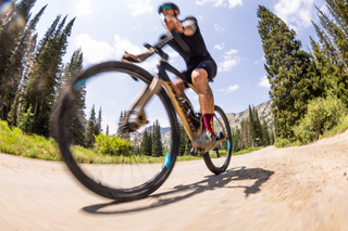 John Collinson biking in the mountains wearing blood KOM Sock