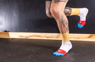 Tattooed legs training in Voltage sunnyside-up socks