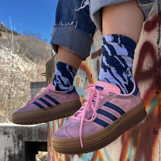 hanging legs wearing blue KOM socks and pink adidas shoes